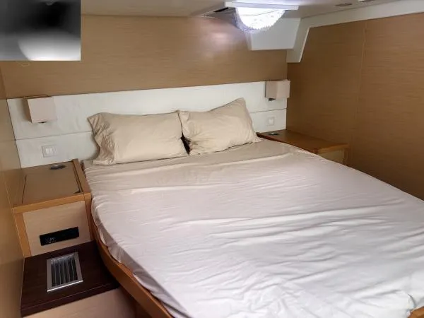 Sea Serenity Yacht Photos Pics Luxurious bedroom interior of 2012 Lagoon 560 yacht with cozy bedding.
