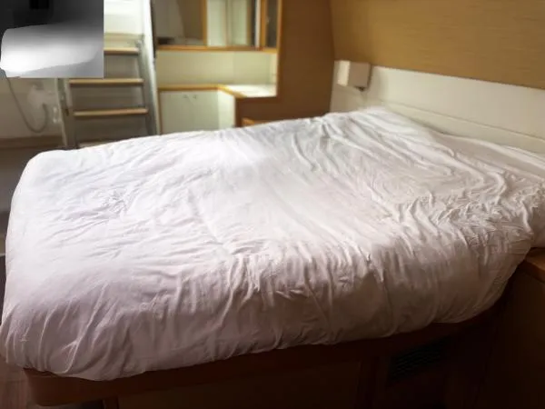 Sea Serenity Yacht Photos Pics Interior cabin of 2012 Lagoon 560 yacht with a neatly made bed.