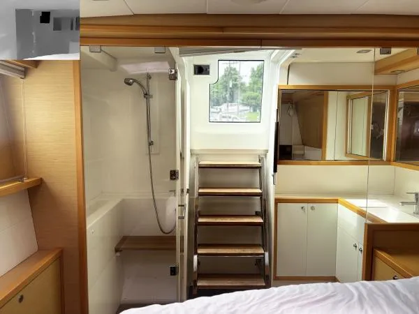 Sea Serenity Yacht Photos Pics Luxurious Lagoon 560 yacht interior, featuring a modern bathroom and wooden accents, 2012 model.