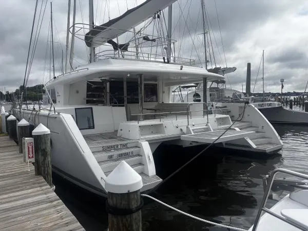 Sea Serenity Yacht Photos Pics 2012 Lagoon 560 catamaran docked at marina under cloudy skies.