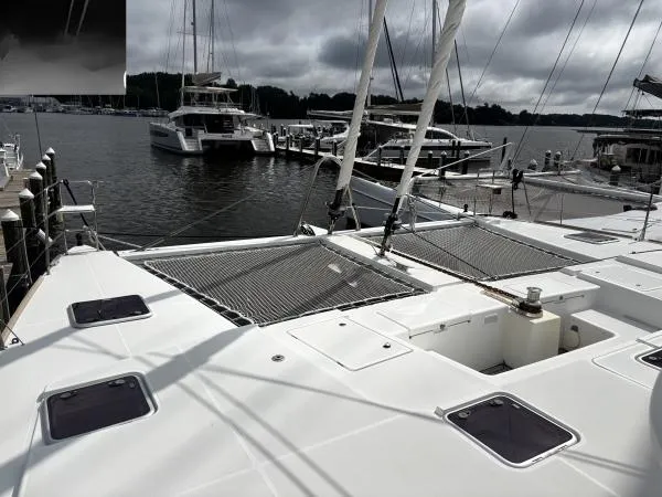 Sea Serenity Yacht Photos Pics Catamaran Lagoon 560, 2012 model, docked at marina with overcast sky.