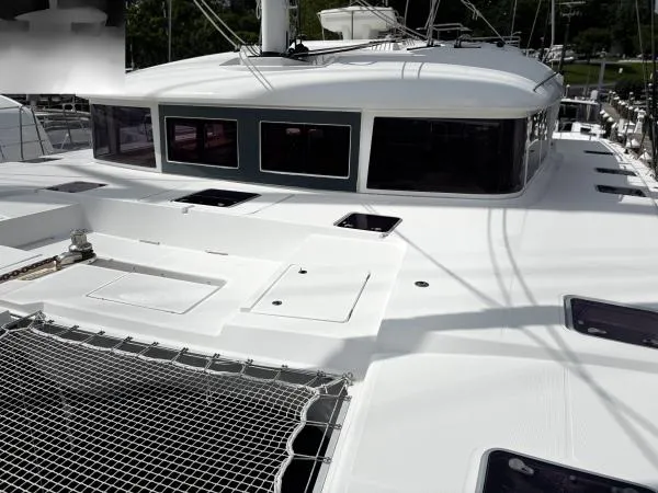 Sea Serenity Yacht Photos Pics 2012 Lagoon 560 catamaran deck with netting and sleek design.