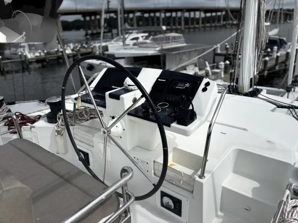 Sea Serenity Yacht Photos Pics Helm of 2012 Lagoon 560 yacht with marina background.