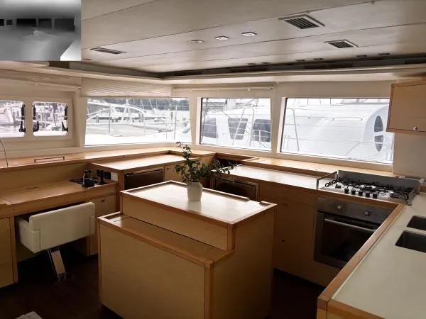 Sea Serenity Yacht Photos Pics Luxurious interior of a 2012 Lagoon 560 yacht with modern kitchen and panoramic windows.