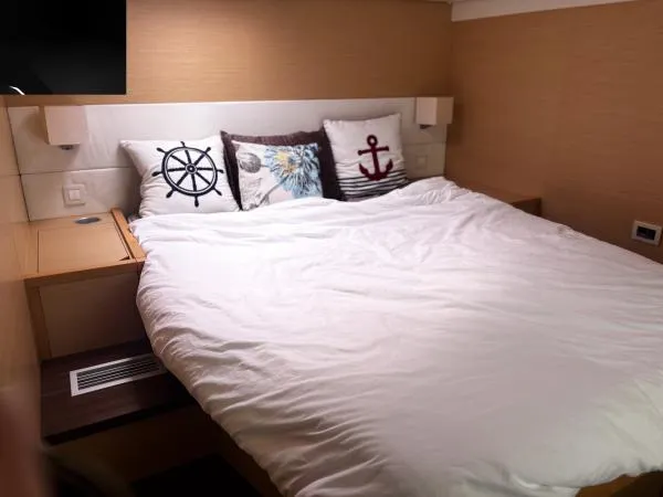 Sea Serenity Yacht Photos Pics Cozy bedroom in 2012 Lagoon 560 yacht with nautical-themed pillows.