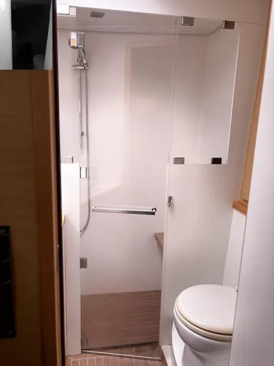 Sea Serenity Yacht Photos Pics Bathroom interior of a 2012 Lagoon 560 yacht, featuring a shower and toilet.