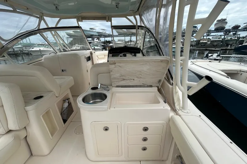  Yacht Photos Pics 2023 Grady-White Freedom 307 boat interior with sink and storage, docked at marina.