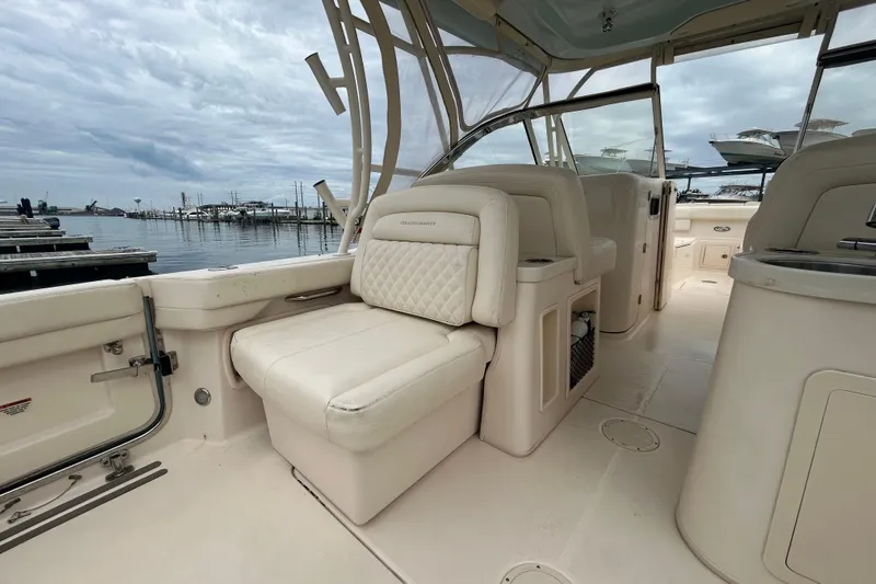  Yacht Photos Pics 2023 Grady-White Freedom 307 boat interior with luxurious seating at marina.