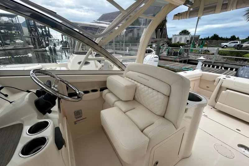  Yacht Photos Pics 2023 Grady-White Freedom 307 boat interior with luxurious seating and steering wheel.