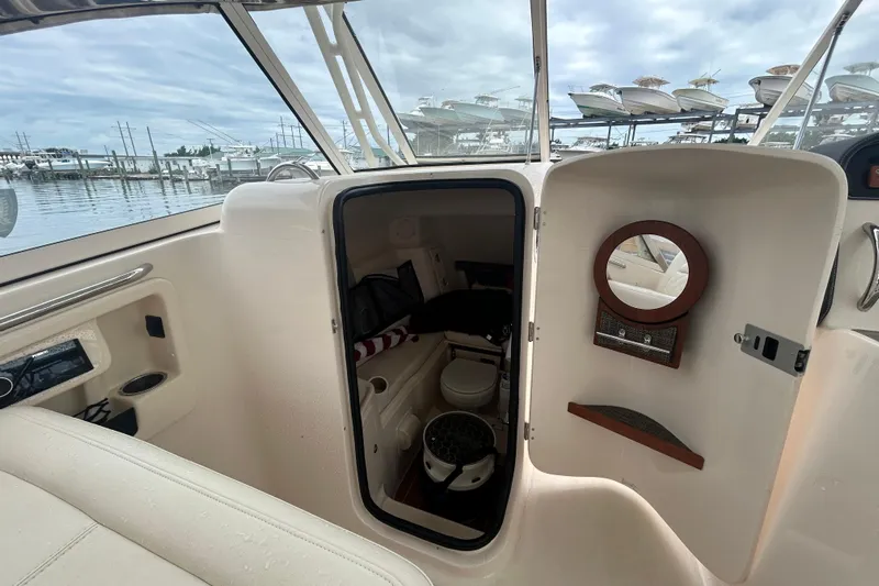  Yacht Photos Pics 2023 Grady-White Freedom 307 boat interior with open cabin door and mirror.