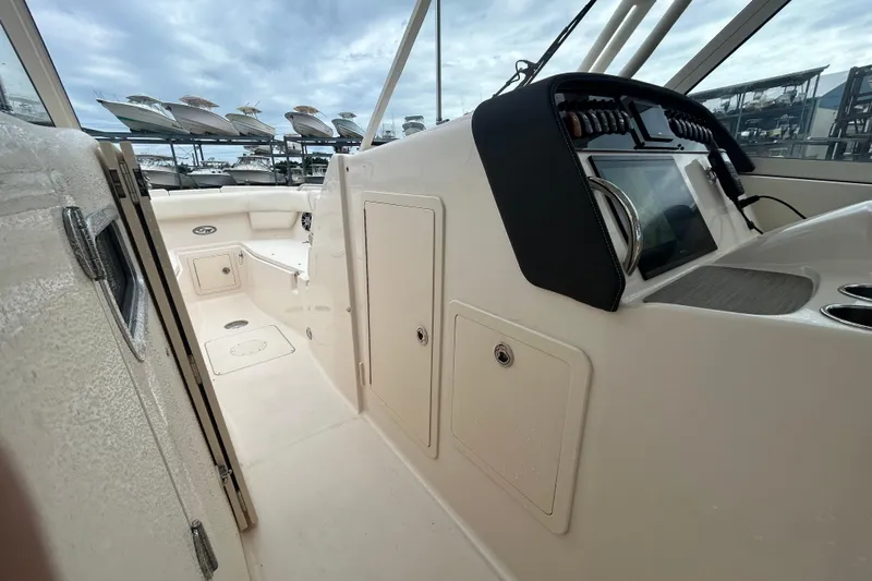  Yacht Photos Pics 2023 Grady-White Freedom 307 boat interior with helm and storage compartments.