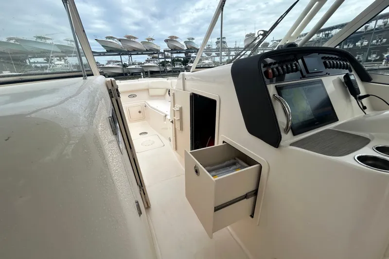  Yacht Photos Pics 2023 Grady-White Freedom 307 boat interior with navigation system and storage drawer.
