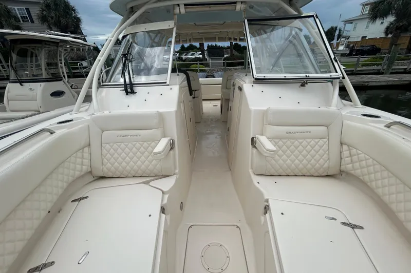  Yacht Photos Pics 2023 Grady-White Freedom 307 boat interior with white quilted seating and open cockpit.