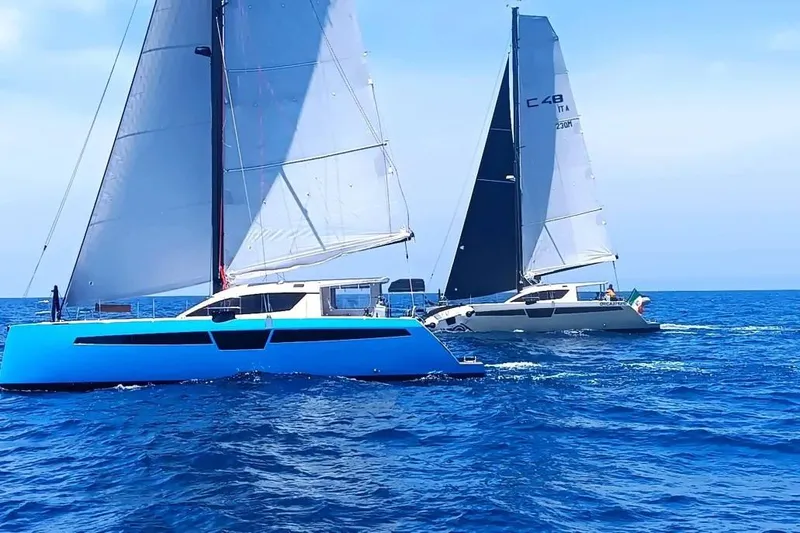 Aurora Yacht Photos Pics Two C-Catamarans 48 sailing on open sea, 2025 model, under clear blue skies.