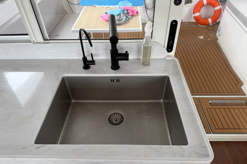 Aurora Yacht Photos Pics Modern kitchen sink on 2025 C-Catamarans 48 yacht with sleek design and wooden deck.