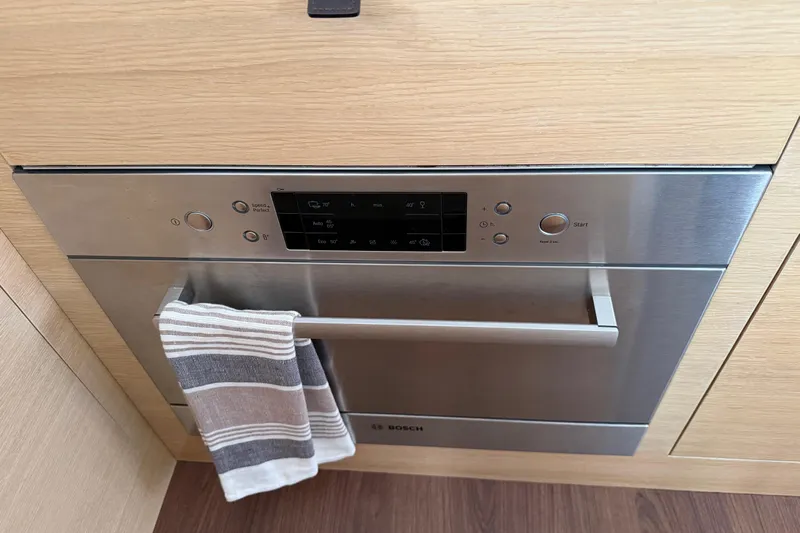 Aurora Yacht Photos Pics Built-in Bosch oven with digital controls and striped towel, in C-Catamarans 48 yacht kitchen.