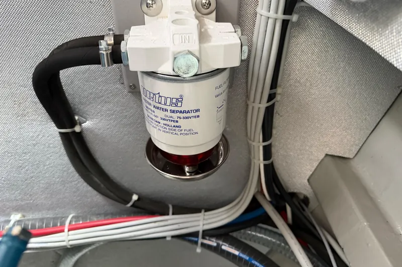 Aurora Yacht Photos Pics Fuel water separator in 2025 C-Catamarans 48 engine room with wiring and hoses.