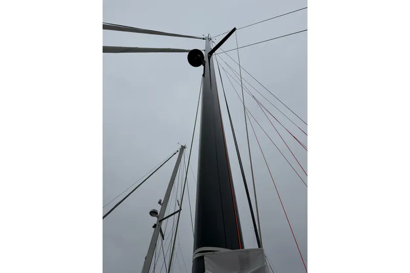 Aurora Yacht Photos Pics Mast of 2025 C-Catamarans 48 against cloudy sky, showcasing rigging details.