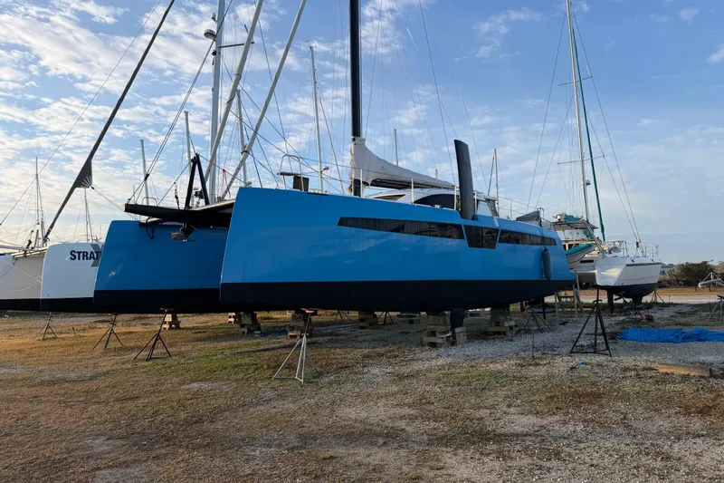 Aurora Yacht Photos Pics 2025 C-Catamarans 48 sailboat on land, blue hull, clear sky background.
