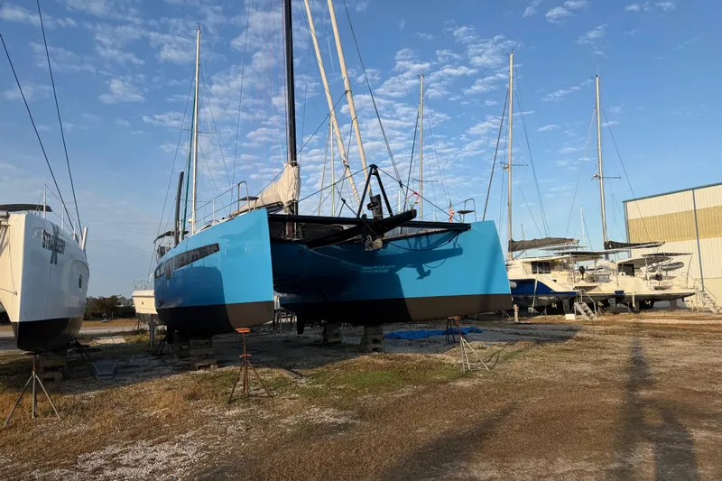 Aurora Yacht Photos Pics 2025 C-Catamarans 48 in dry dock, surrounded by other boats under a clear sky.