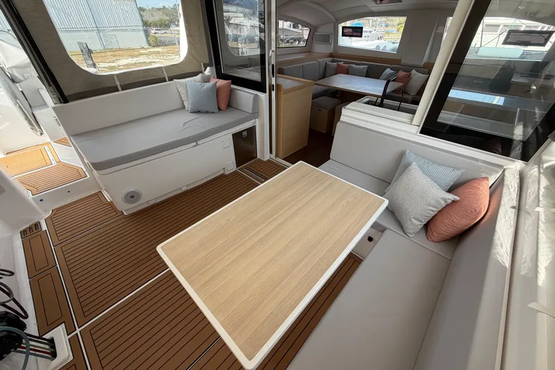 Aurora Yacht Photos Pics Luxurious interior of 2025 C-Catamarans 48 with elegant seating and wooden flooring.