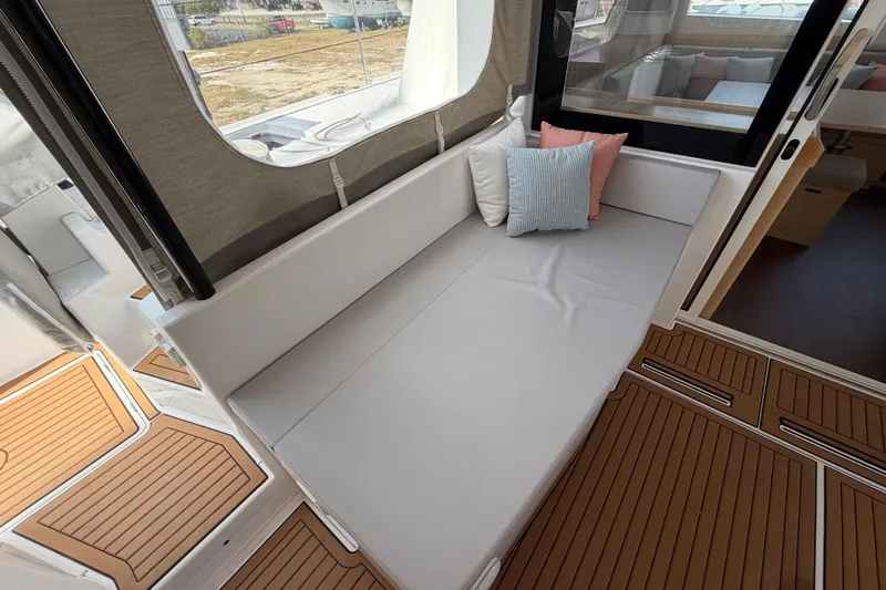 Aurora Yacht Photos Pics 2025 C-Catamarans 48 interior with cushioned seating and decorative pillows.