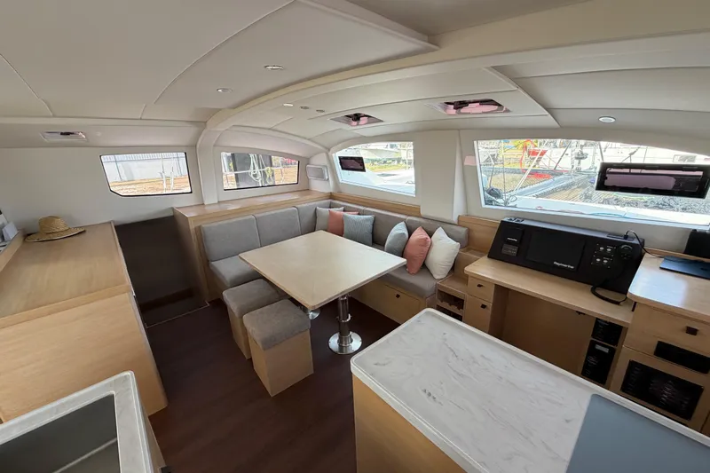 Aurora Yacht Photos Pics Luxurious interior of 2025 C-Catamarans 48 with modern seating and dining area.