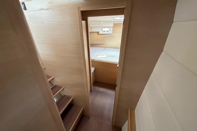 Aurora Yacht Photos Pics Interior view of 2025 C-Catamarans 48, featuring wooden stairs and cozy cabin.