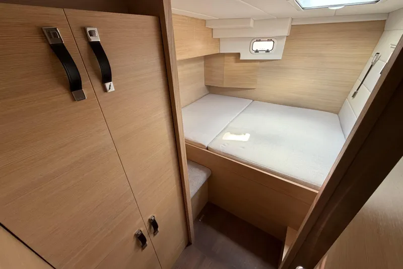 Aurora Yacht Photos Pics 2025 C-Catamarans 48 interior cabin with bed and wooden storage.