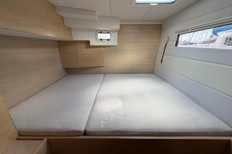 Aurora Yacht Photos Pics Modern interior cabin of 2025 C-Catamarans 48 with cozy bed and natural light.