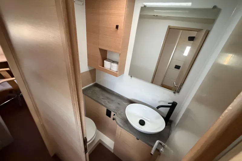 Aurora Yacht Photos Pics Modern bathroom in 2025 C-Catamarans 48, featuring sleek sink and wooden cabinetry.