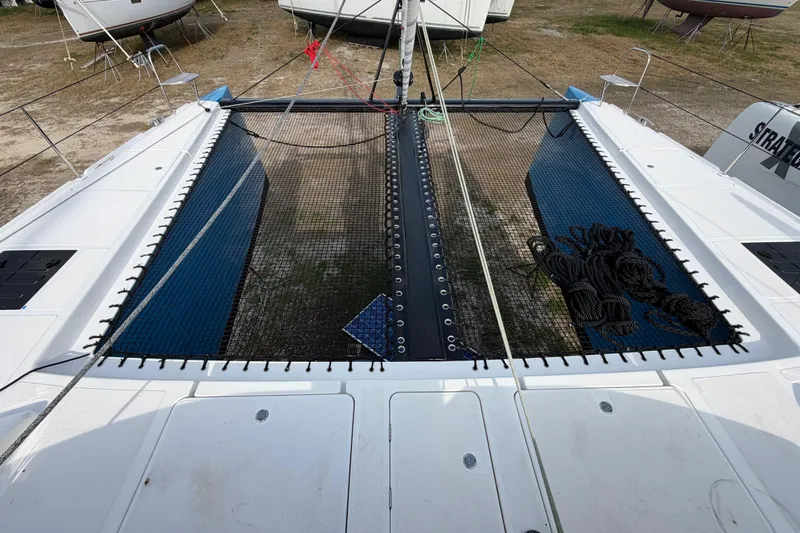 Aurora Yacht Photos Pics 2025 C-Catamarans 48 deck with netting and ropes, docked on land.