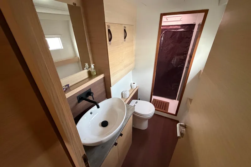 Aurora Yacht Photos Pics Modern bathroom in 2025 C-Catamarans 48, featuring sleek sink, toilet, and shower.