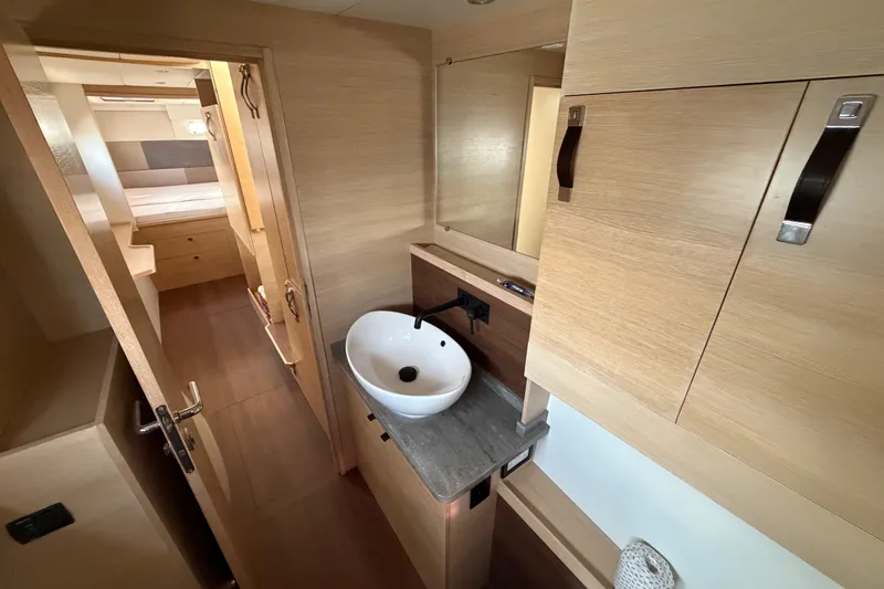Aurora Yacht Photos Pics Modern bathroom interior of 2025 C-Catamarans 48, featuring sleek wood finishes and a stylish sink.