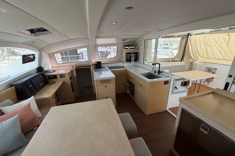 Aurora Yacht Photos Pics Luxurious interior of 2025 C-Catamarans 48, featuring modern kitchen and dining area.