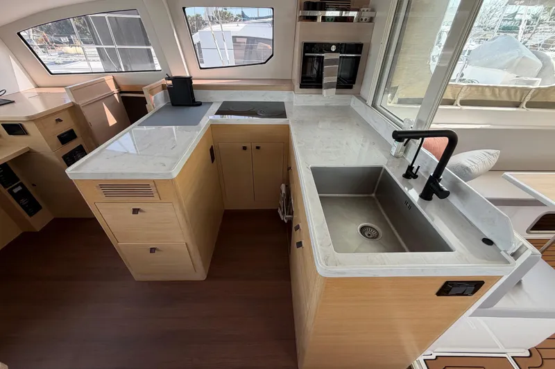 Aurora Yacht Photos Pics Modern kitchen interior of 2025 C-Catamarans 48 with sleek countertops and stainless steel sink.