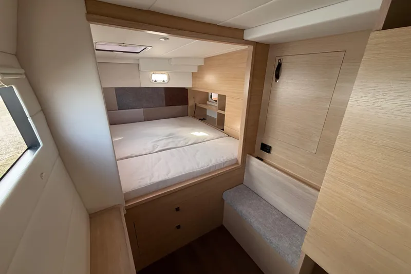 Aurora Yacht Photos Pics Modern interior of 2025 C-Catamarans 48, featuring a cozy bedroom with natural wood finishes.