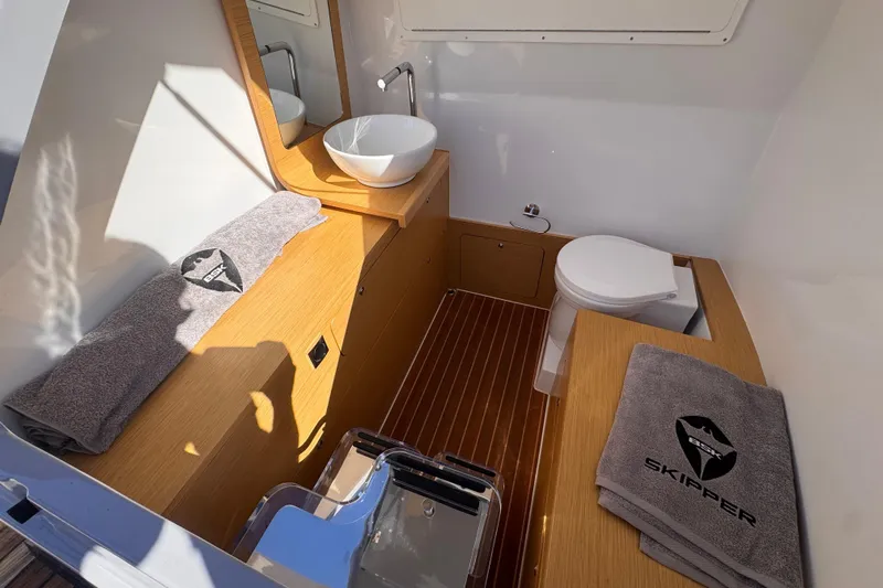 Yacht Photos Pics Luxurious bathroom in 2025 Skipper-BSK 38NC boat with modern fixtures and branded towels.
