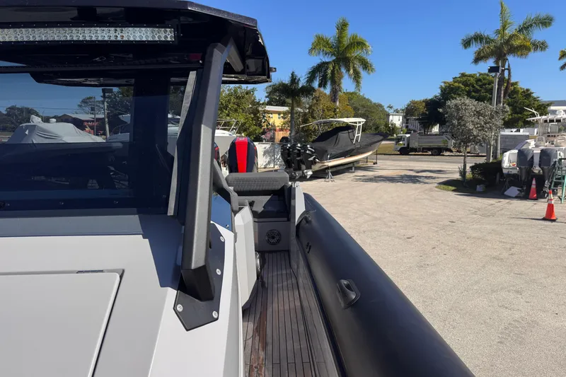  Yacht Photos Pics 2025 Skipper-BSK 38NC boat docked, surrounded by palm trees and other vessels.