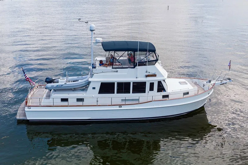First Light Yacht Photos Pics 2007 Grand Banks 47 Classic yacht on calm water, featuring a sleek design and spacious deck.