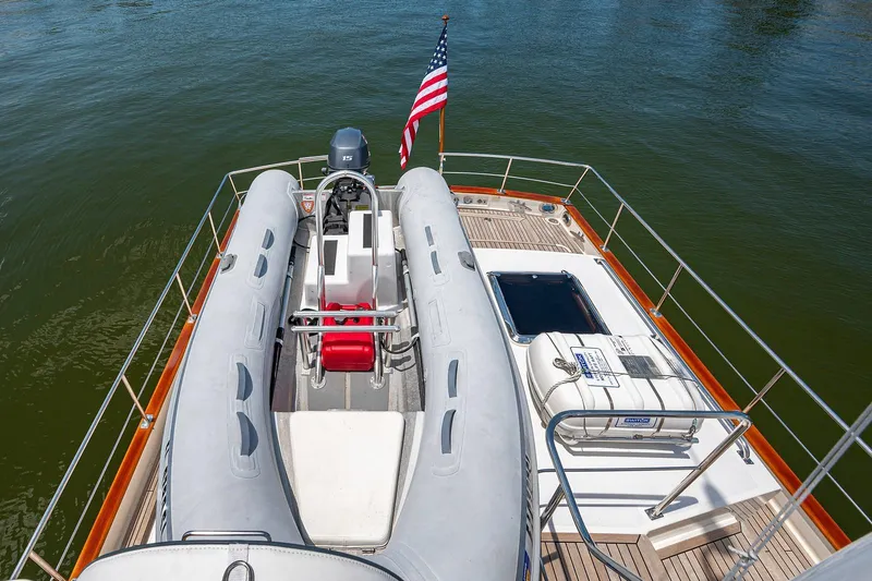 First Light Yacht Photos Pics 2007 Grand Banks 47 Classic yacht deck with inflatable boat and American flag.