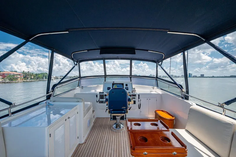 First Light Yacht Photos Pics 2007 Grand Banks 47 Classic yacht helm with seating, overlooking serene waters.