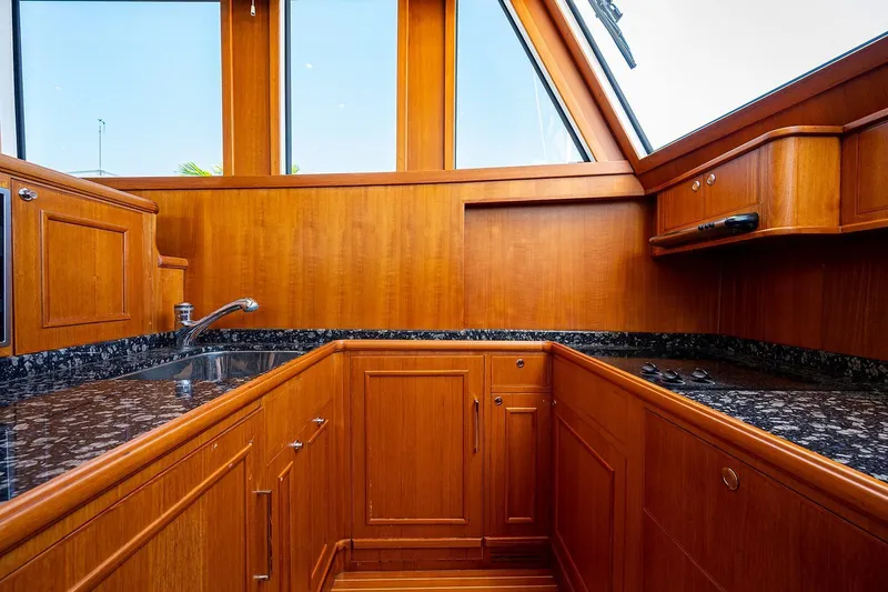 First Light Yacht Photos Pics Luxurious wooden kitchen interior of 2007 Grand Banks 47 Classic yacht.