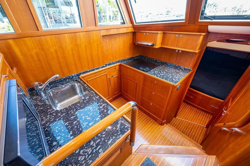 First Light Yacht Photos Pics 2007 Grand Banks 47 Classic yacht interior with wood cabinetry and granite countertops.