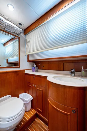 First Light Yacht Photos Pics Luxurious bathroom in 2007 Grand Banks 47 Classic yacht with wooden cabinetry and modern fixtures.