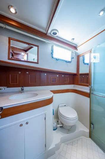 First Light Yacht Photos Pics Luxurious bathroom in 2007 Grand Banks 47 Classic yacht with modern fixtures and wood accents.