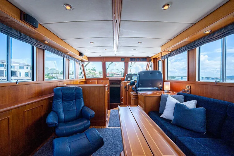 First Light Yacht Photos Pics Interior of 2007 Grand Banks 47 Classic yacht, featuring luxurious seating and panoramic windows.