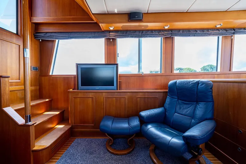First Light Yacht Photos Pics Luxurious 2007 Grand Banks 47 Classic yacht interior with leather chair and TV.