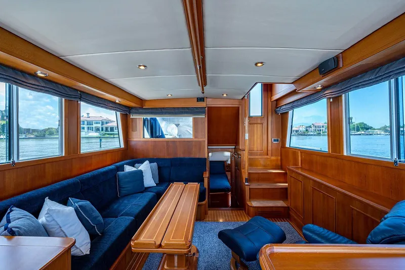 First Light Yacht Photos Pics Luxurious interior of 2007 Grand Banks 47 Classic yacht with wooden furnishings and blue seating.