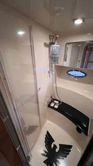 Bella Blue Yacht Photos Pics 2010 Formula 45 yacht bathroom with shower, porthole, and eagle floor design.